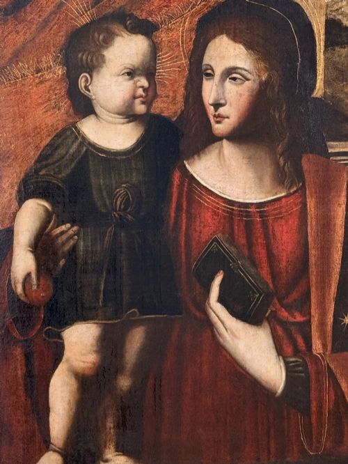 fig 1. An oil on canvas painting featuring the Virgin Mary holding a small book alongside the Christ Child, enclosed in a dark ebonised frame with a gilt inner border.