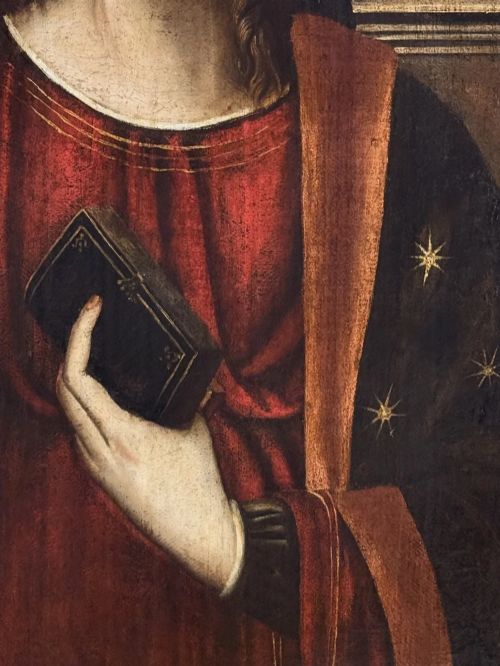 fig 4. An oil on canvas painting featuring the Virgin Mary holding a small book alongside the Christ Child, enclosed in a dark ebonised frame with a gilt inner border.