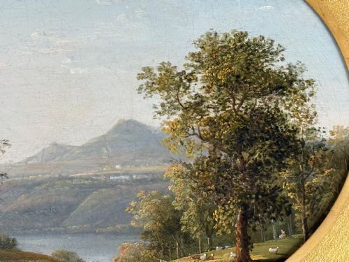 fig 2. An 18th-century classical landscape oil painting set within an oval spandrel inside an ornate giltwood frame.