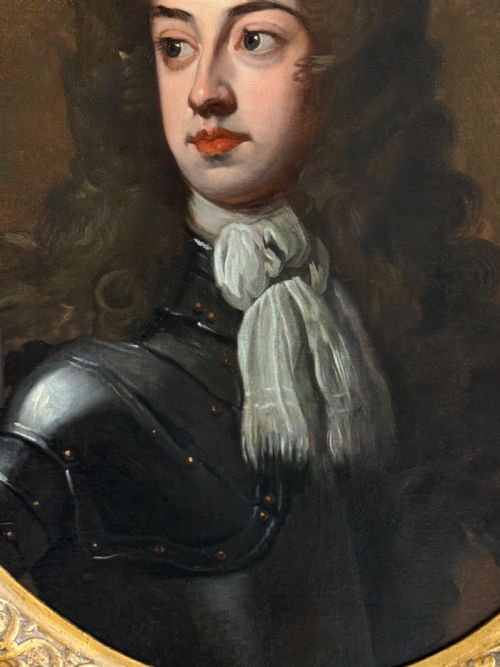 fig 6. An oval late 17th-century oil portrait of a long-haired nobleman in dark plate armour with a white cravat, set within a carved gilt frame.