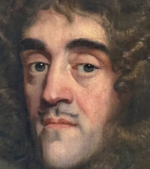 fig 6. A half-length oil painting depicting a 17th-century gentleman with long dark curled hair wearing polished steel plate armour over a red sash against a dark backdrop.