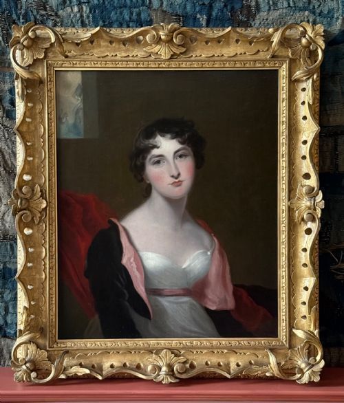 fig 1. A Regency period half-length oil portrait painting depicting a young woman with dark curls, wearing a white Empire dress and a red draped shawl against a dark background.