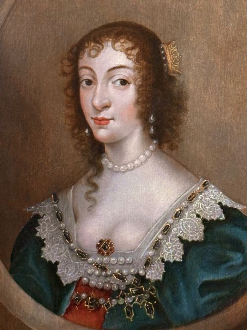 fig 2. A 17th-century oil portrait depicting Queen Henrietta Maria within a feigned oval frame, featuring lace details and pearl jewellery.