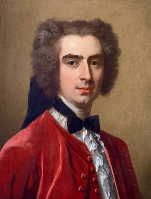 fig 9. An eighteenth-century oil portrait of a gentleman in a scarlet coat with a white cravat, set inside a carved giltwood frame.