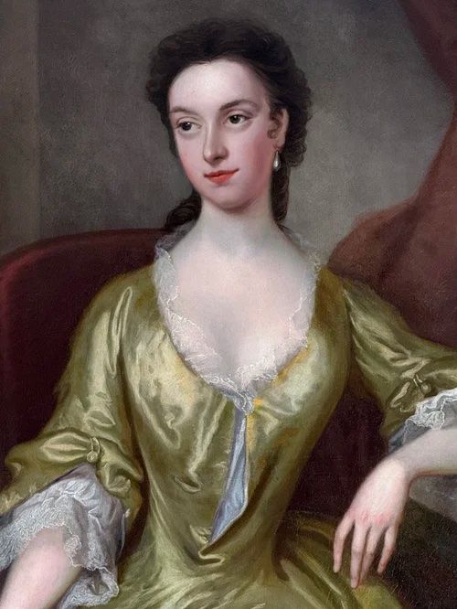 fig 3. An 18th-century oil portrait depicting a seated lady in a chartreuse silk dress with lace trim holding a book.