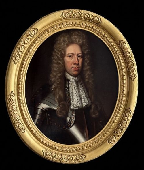 fig 8. A late 17th-century oil painting depicting a gentleman wearing plate armour, a powdered wig, and a lace cravat, set within an oval carved gilded frame.