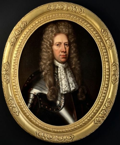 fig 7. A late 17th-century oil painting depicting a gentleman wearing plate armour, a powdered wig, and a lace cravat, set within an oval carved gilded frame.