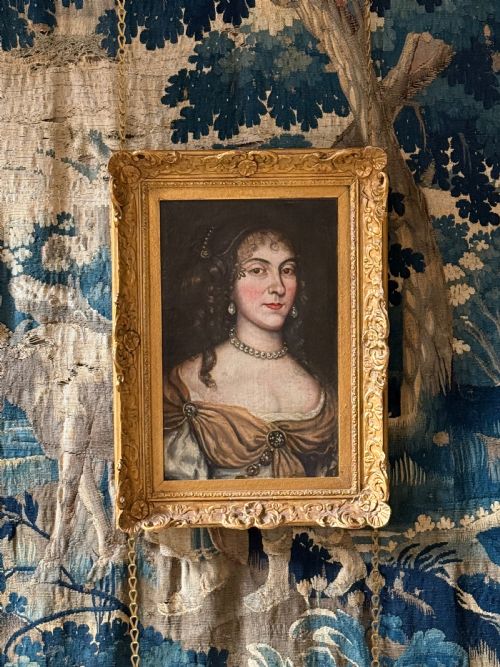 fig 2. A seventeenth-century oil painting on canvas depicting a noblewoman with pearl jewellery, housed within an ornate carved gilt frame.