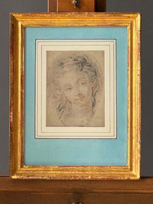 fig 1. An 18th-century French Rococo chalk portrait drawing of a woman, displayed within a pale blue mount and an antique gilt frame.
