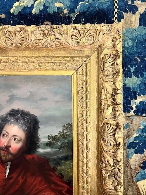 fig 4. An 18th-century oil painting on canvas depicting two seated men in historical attire, presented in a deeply carved gold giltwood frame.