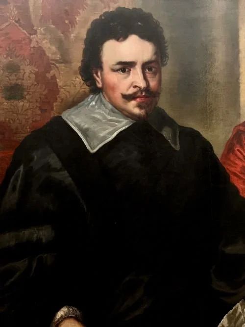fig 6. An 18th-century oil painting on canvas depicting two seated men in historical attire, presented in a deeply carved gold giltwood frame.