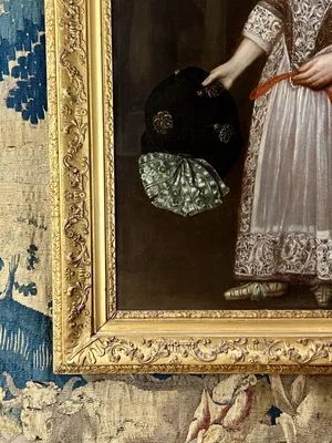 fig 2. A 17th-century oil portrait depicting a young boy standing beside a dog, framed in an ornate giltwood border.