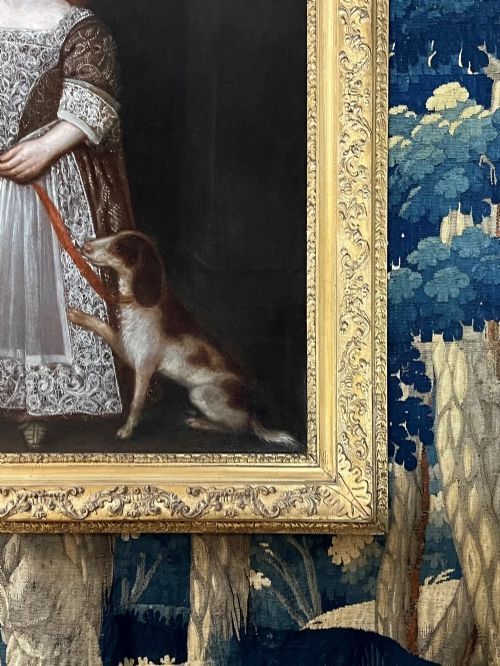 fig 4. A 17th-century oil portrait depicting a young boy standing beside a dog, framed in an ornate giltwood border.
