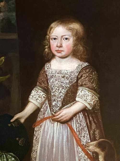fig 5. A 17th-century oil portrait depicting a young boy standing beside a dog, framed in an ornate giltwood border.