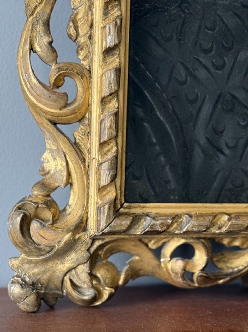 fig 4. An oil painting depicting a seventeenth-century gentleman wearing a dark embroidered doublet and pleated white ruff, encased in a heavily carved giltwood frame.