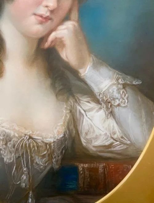 fig 3. An 18th-century oval pastel portrait depicting a woman with styled brown hair resting her chin on her hand, mounted in a gold gilt frame.