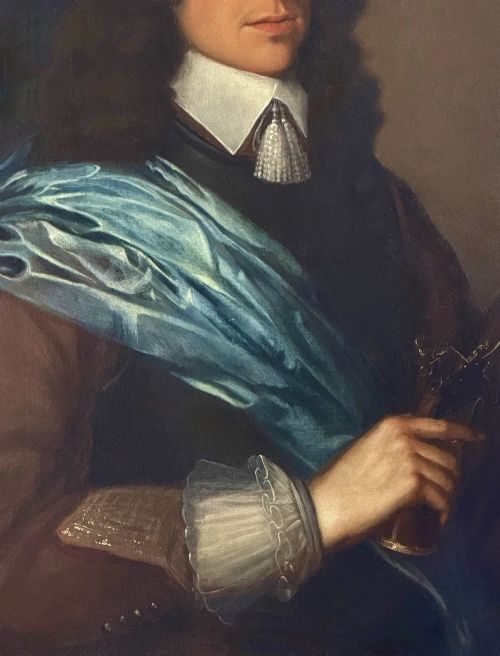 fig 3. A half-length 17th-century portrait painting of a gentleman holding a pistol, wearing a blue sash, framed in a carved giltwood frame.