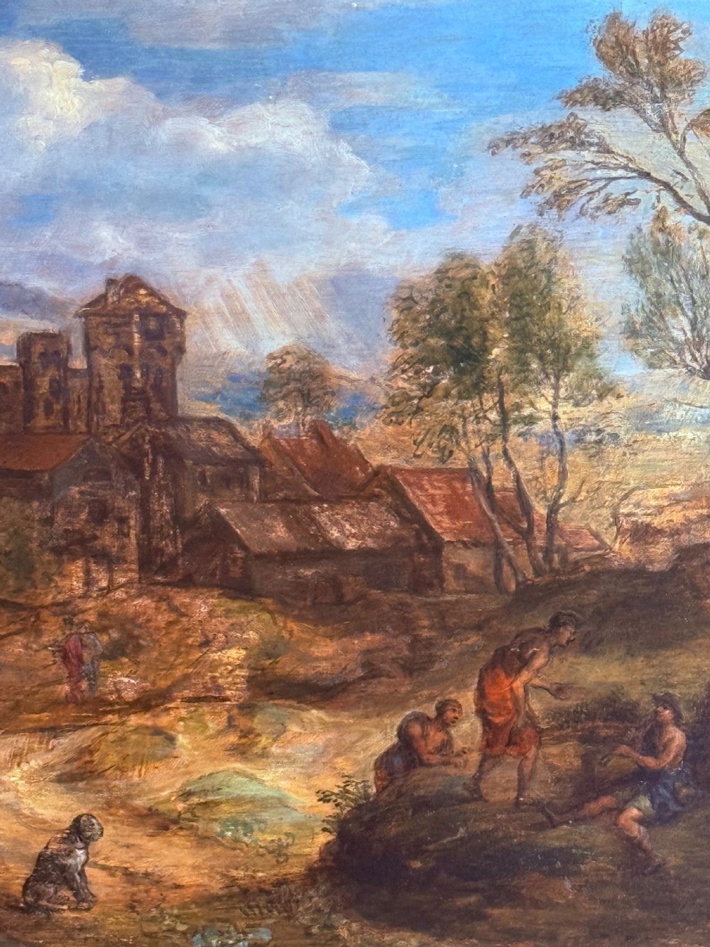 An oil painting on wooden panel depicting an idyllic pastoral landscape with classical figures, stone buildings, and distant mountains, set within a carved gilded frame. View II