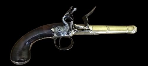 fig 1. A pair of 18th-century English flintlock turn-off pistols featuring brass cannon barrels, steel lock mechanisms, and smooth walnut stocks.