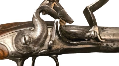 QUEEN ANNE SILVERMOUNTED 18 BORE FLINTLOCK HOLSTER PISTOL BY R WILLOUGHBY BIRMINGHAMEARLY 18THCENTURY ENGLISH FLINTLOCK PISTOL SILVERWIRE INLAID WALNUT GRIP SILVER GROTESQUE BUTT CAP WITH SILVER VACANT CARTOUCHES TO THE TOP AND THE SIDE OF THE STOCK CIRCA 1730 - ADDITIONAL PHOTO 4
