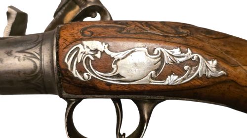 QUEEN ANNE SILVERMOUNTED 18 BORE FLINTLOCK HOLSTER PISTOL BY R WILLOUGHBY BIRMINGHAMEARLY 18THCENTURY ENGLISH FLINTLOCK PISTOL SILVERWIRE INLAID WALNUT GRIP SILVER GROTESQUE BUTT CAP WITH SILVER VACANT CARTOUCHES TO THE TOP AND THE SIDE OF THE STOCK CIRCA 1730 - ADDITIONAL PHOTO 10