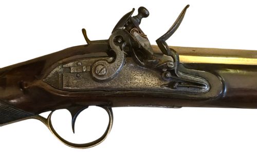 fig 4. Late eighteenth-century British flintlock blunderbuss featuring a flared brass barrel, dark polished walnut stock, steel flintlock action, top-mounted sprung bayonet, and a separate wooden ramrod.