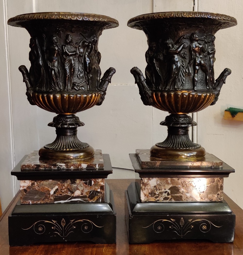 A fine pair of Bronze mid-19th century Campana. The shaped patinated bronze urns with marble pedestals. 