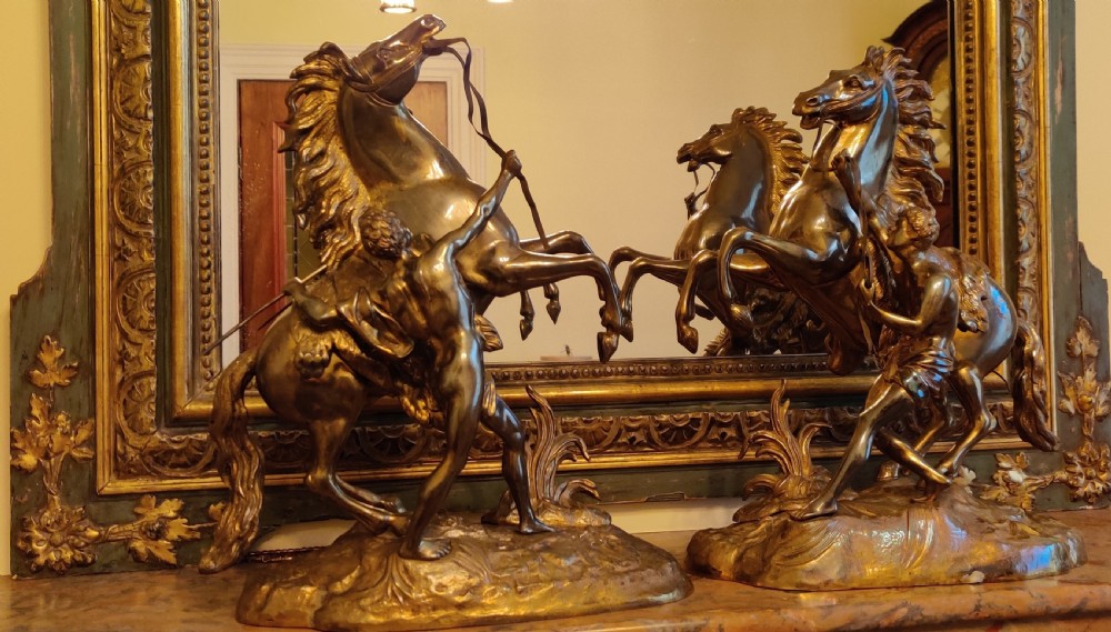 A PAIR OF LATE 19TH CENTURY GILT BRONZE FRENCH MARLY HORSES.
After GUILLAUME COSTOU THE ELDER (French, 1677-1746). 
