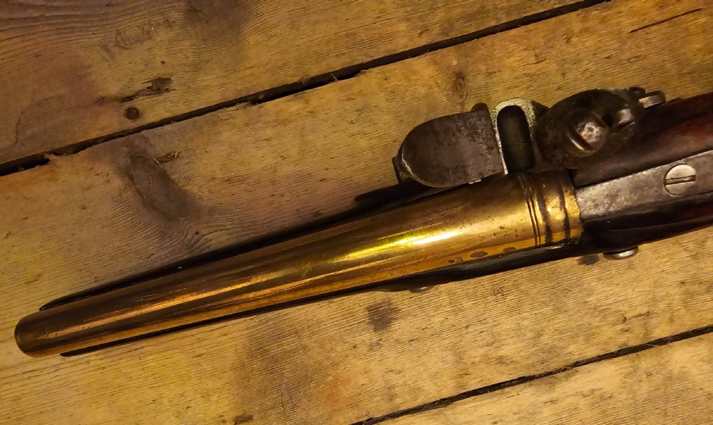 A late 18th-century Light Dragoon service flintlock pistol featuring a brass barrel, dark walnut stock, and steel ignition lock mechanism. View III