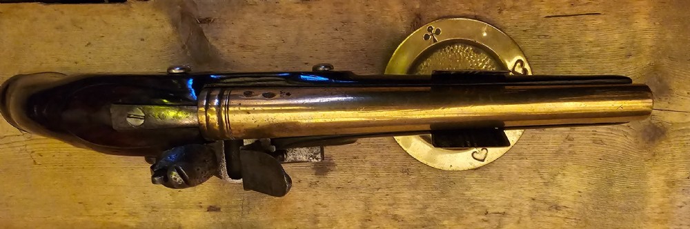 A late 18th-century Light Dragoon service flintlock pistol featuring a brass barrel, dark walnut stock, and steel ignition lock mechanism. View VI