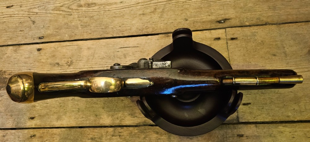 A late 18th-century Light Dragoon service flintlock pistol featuring a brass barrel, dark walnut stock, and steel ignition lock mechanism. View VIII