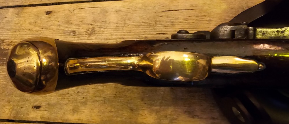 A late 18th-century Light Dragoon service flintlock pistol featuring a brass barrel, dark walnut stock, and steel ignition lock mechanism. View IX