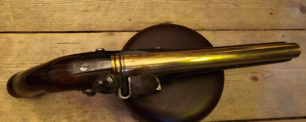 A late 18th-century Light Dragoon service flintlock pistol featuring a brass barrel, dark walnut stock, and steel ignition lock mechanism. View XI