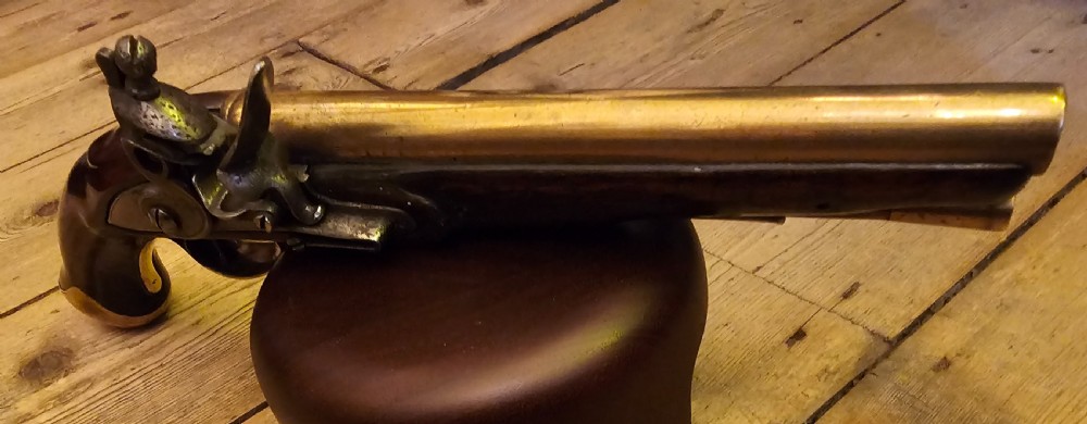 A late 18th-century Light Dragoon service flintlock pistol featuring a brass barrel, dark walnut stock, and steel ignition lock mechanism. View XII