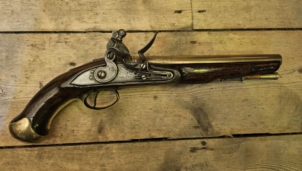 A late 18th-century Light Dragoon service flintlock pistol featuring a brass barrel, dark walnut stock, and steel ignition lock mechanism. View XIV