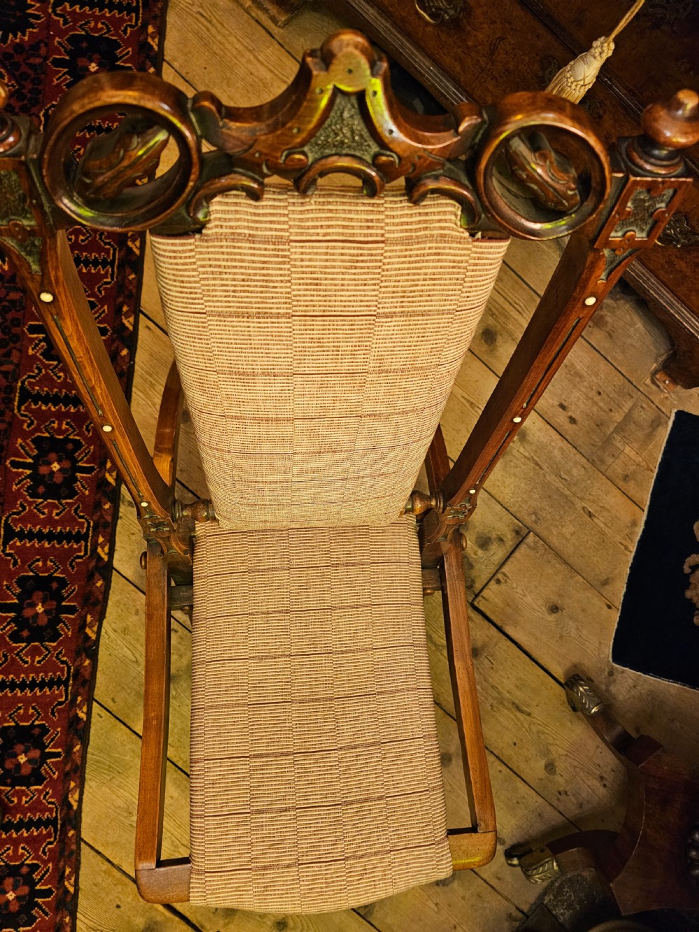 A nineteenth-century carved walnut folding campaign chair with woven fabric upholstery, turned finials, and bone inlay detail. View II