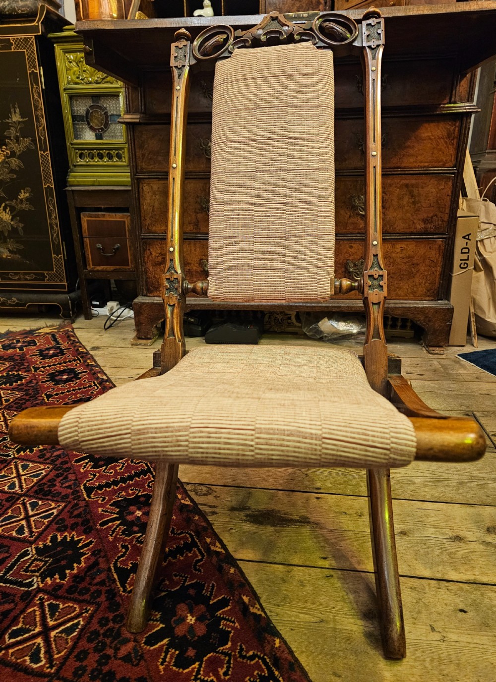 A nineteenth-century carved walnut folding campaign chair with woven fabric upholstery, turned finials, and bone inlay detail. View III