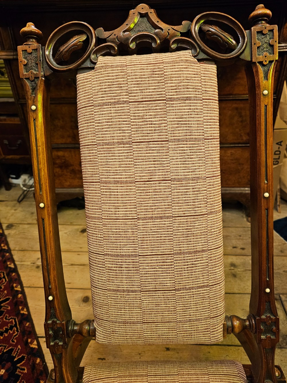 A nineteenth-century carved walnut folding campaign chair with woven fabric upholstery, turned finials, and bone inlay detail. View V