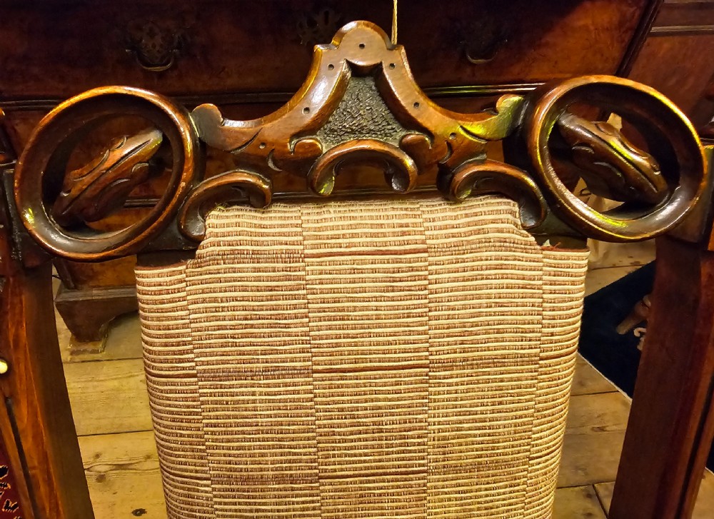 A nineteenth-century carved walnut folding campaign chair with woven fabric upholstery, turned finials, and bone inlay detail. View IX
