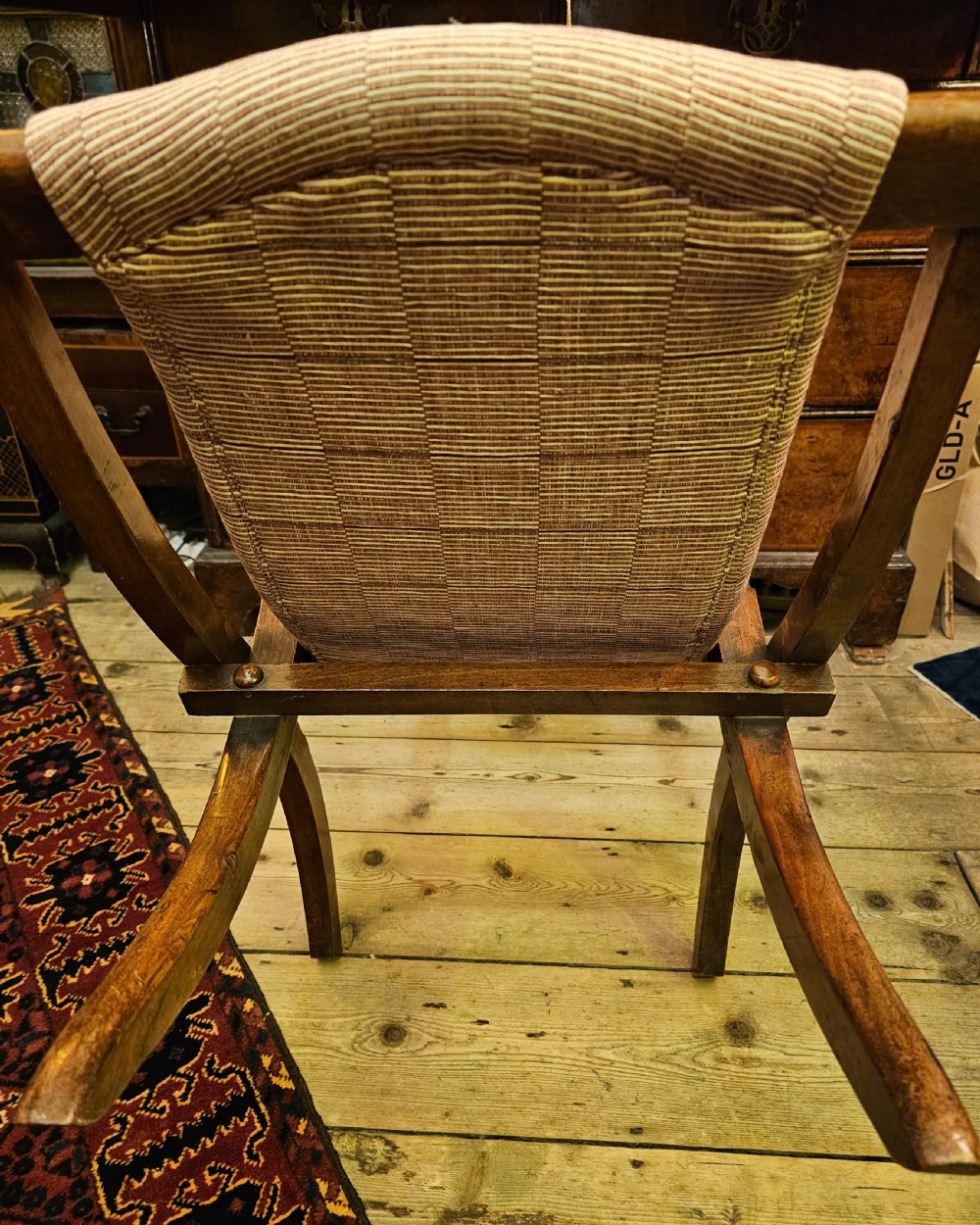 A nineteenth-century carved walnut folding campaign chair with woven fabric upholstery, turned finials, and bone inlay detail. View XIII