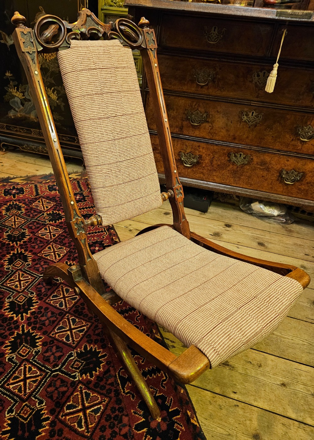 A nineteenth-century carved walnut folding campaign chair with woven fabric upholstery, turned finials, and bone inlay detail. View XIV