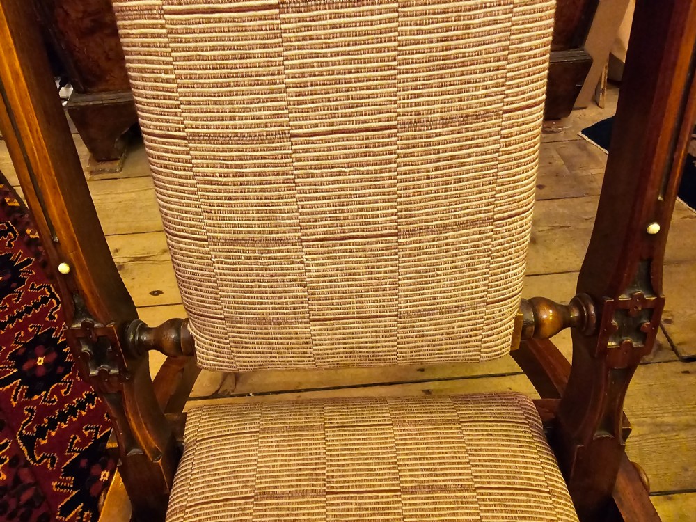 A nineteenth-century carved walnut folding campaign chair with woven fabric upholstery, turned finials, and bone inlay detail. View XV