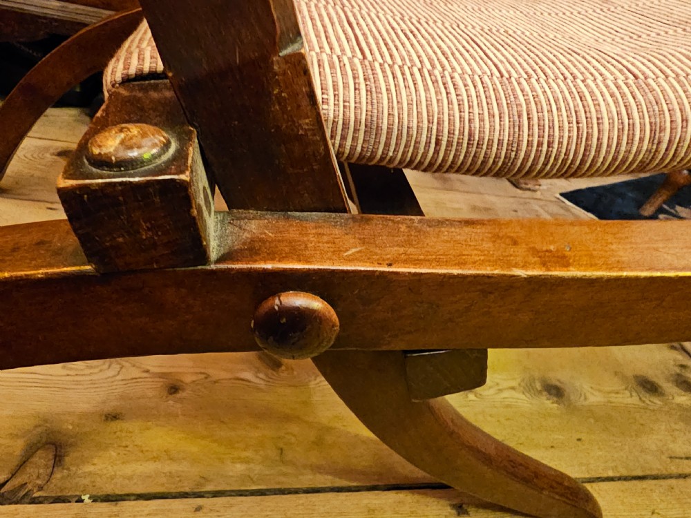 A nineteenth-century carved walnut folding campaign chair with woven fabric upholstery, turned finials, and bone inlay detail. View XVII