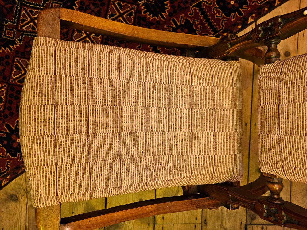 A nineteenth-century carved walnut folding campaign chair with woven fabric upholstery, turned finials, and bone inlay detail. View XVIII