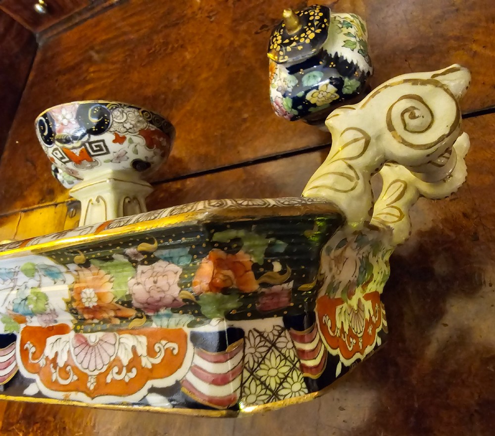 An ornate early 19th-century Masons ironstone double inkstand featuring a central sander, two lidded inkwells, and intricate Imari-style floral patterns. View VI