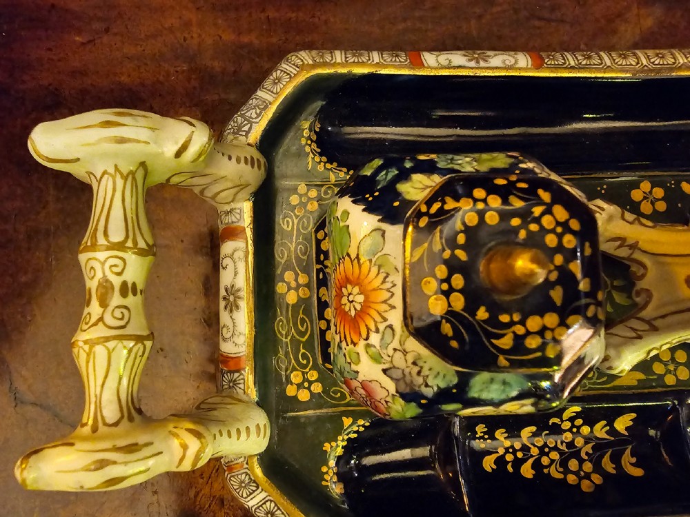 An ornate early 19th-century Masons ironstone double inkstand featuring a central sander, two lidded inkwells, and intricate Imari-style floral patterns. View XVIII