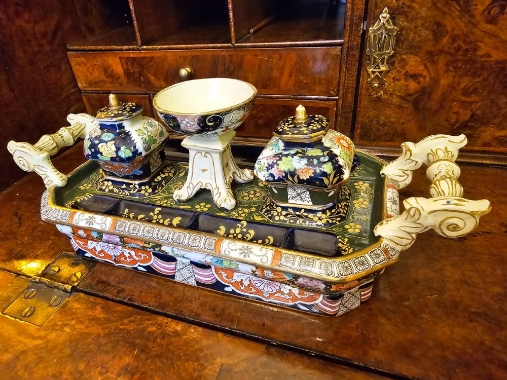 An ornate early 19th-century Masons ironstone double inkstand featuring a central sander, two lidded inkwells, and intricate Imari-style floral patterns. View XIX