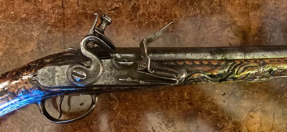 An 18th-century Balkan Ottoman flintlock holster pistol featuring a carved wooden stock, steel barrel, and a bulbous pommel. View III