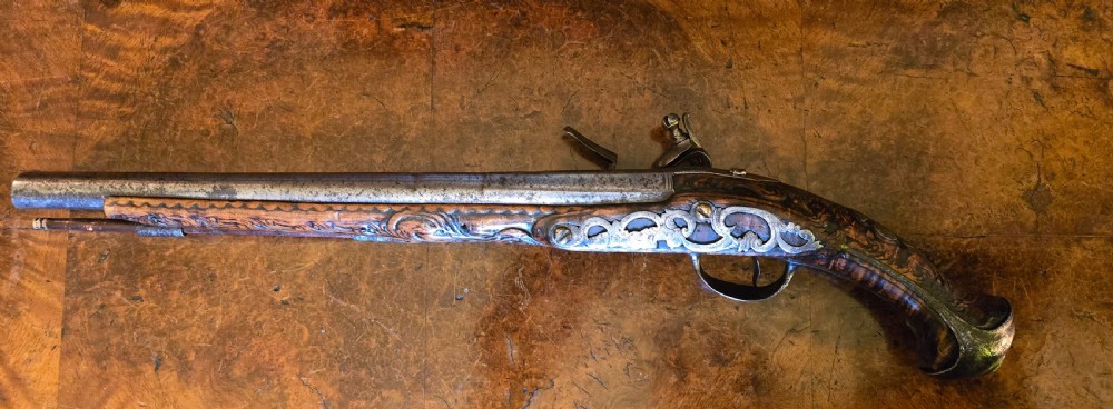 An 18th-century Balkan Ottoman flintlock holster pistol featuring a carved wooden stock, steel barrel, and a bulbous pommel. View VI