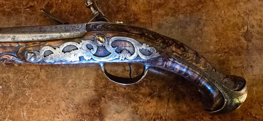 An 18th-century Balkan Ottoman flintlock holster pistol featuring a carved wooden stock, steel barrel, and a bulbous pommel. View VIII